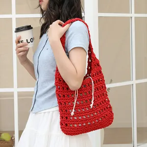 Red handmade knitted cotton shoulder bag with hollow-out design and inner pouch.