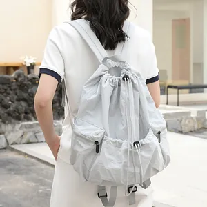 Casual Japanese style drawstring backpack made of grid nylon fabric in light grey color