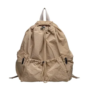 Minimalist khaki nylon grid backpack featuring a casual drawstring closure and large capacity
