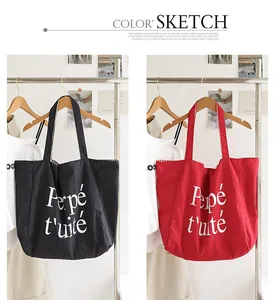 Stylish black and red nylon tote bags with white letter print hanging on a clothing rack