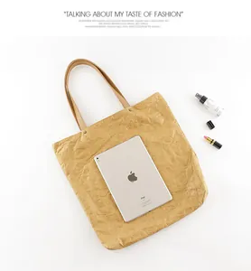 Vintage wrinkled DuPont paper tote bag shown with an iPad for clear size reference
