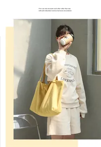 Woman carrying a vibrant yellow canvas tote bag in a casual sunny street setting