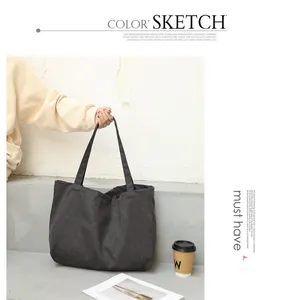 Minimalist Japanese style dark grey canvas tote bag shown in a lifestyle setting
