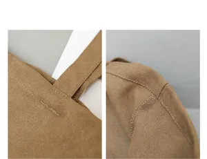 Macro detail view showing high-quality stitching and texture on brown canvas tote bag