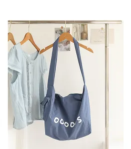 Japanese style blue nylon crossbody bag with letter print and knot detail