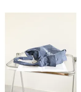 Stylish Japanese style blue nylon crossbody bag with white letter print and knotted strap