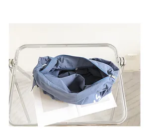 Detailed view of blue nylon crossbody bag featuring secure interior zipper pocket