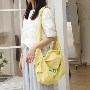 Casual yellow nylon crossbody bag with knotted strap and side pocket design for women