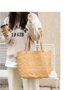 Stylish casual kraft paper tote bag with pleated texture carried by a model outdoors
