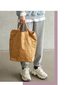 Detail view of a vintage DuPont paper tote bag in a Japanese casual street style.