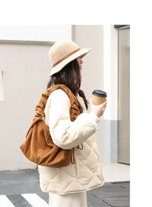 Stylish brown corduroy shoulder bag for women shown in a casual outdoor lifestyle setting