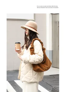 Close-up of a vintage brown corduroy shoulder bag for women in an urban setting
