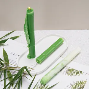 Close-up of green bamboo-shaped long pole candles with a realistic melting flame.