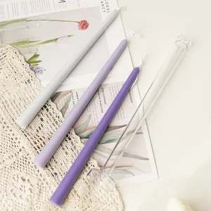 Detail of 30cm long tapered candles and transparent acrylic DIY candle mold on lace.