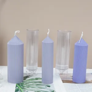 Macro detail of church spire striped cylinder candle molds and finished wax items