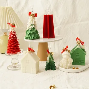 Detailed shot of finished Christmas tree and snowman scented candles in festive colors