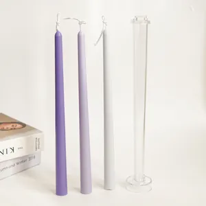Detail of 30cm taper candle mold with finished purple and light grey wax candles on white