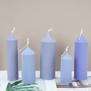 Detailed view of multiple lilac ribbed pillar candles in various sizes for home decor