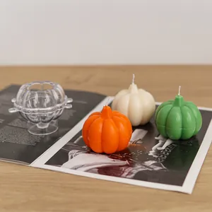 Detail showing transparent pumpkin candle mold with colorful finished DIY wax candles