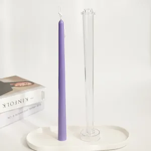 Clear 30cm plastic taper candle mold and finished purple candle on a white tray