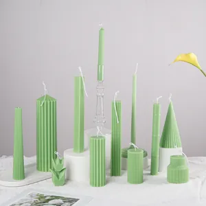 Artistic collection of green handmade scented candles in various shapes for home decor