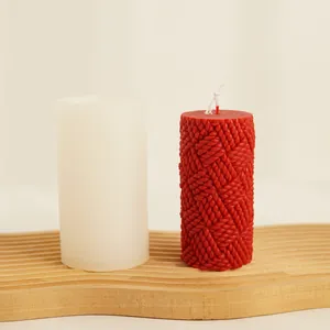 Detailed macro shot of the knitted texture on red candle beside its silicone mold