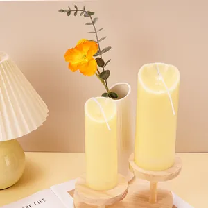 Detailed macro view of slanted top pillar candle molds in a cozy and warm home setting