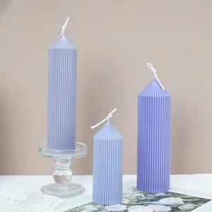 Detail of purple fluted pillar candles with elegant ribbed texture and spire tops.