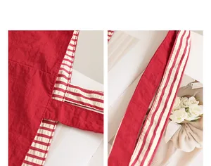 Close-up detail of red and striped nylon tote bag showing stitching and fabric texture