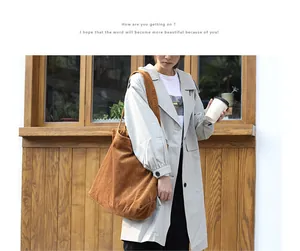 Detailed view of a brown corduroy tote bag worn by a model in a casual outdoor setting