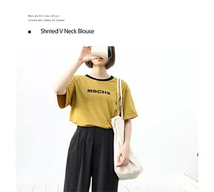 Casual washed canvas tote bag carried by model in a minimalist lifestyle setting