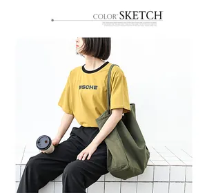 Detail lifestyle view of a large washed green canvas tote bag for casual daily use