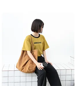 Casual large capacity washed brown canvas tote bag shown in a lifestyle setting