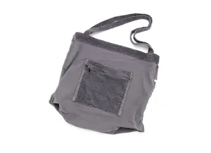 Macro view of gray corduroy tote bag highlighting front zipper pocket and fabric texture