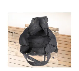Interior view of a spacious black washed canvas tote bag showing the inner pocket