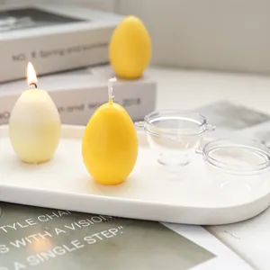 Detailed macro view of egg-shaped candle plastic molds with finished yellow wax candles