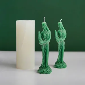 Molde detallado de silicona de diosa junto a velas de cera verde para aromaterapia