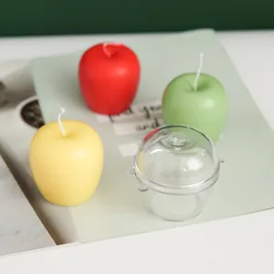 Clear apple-shaped plastic mold shown with finished red green and yellow candles
