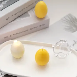 Close-up of handmade egg-shaped aromatherapy candle with its clear PC plastic mold.