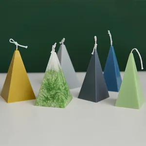 Selection of colorful pyramid-shaped scented candles in a geometric minimalist setup
