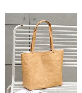 A close-up view showing the unique crumpled texture of this vintage DuPont paper tote bag.