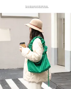 Side view of vibrant green corduroy shoulder bag with elegant drawstring design