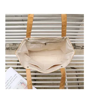 Interior view of a vintage DuPont paper tote bag showing the zipper pocket and lining
