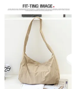 Detailed view of the minimalist khaki nylon shoulder bag with stylish fold texture