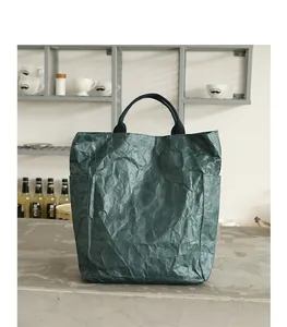 Close-up view of a dark green DuPont paper tote bag featuring unique wrinkled texture