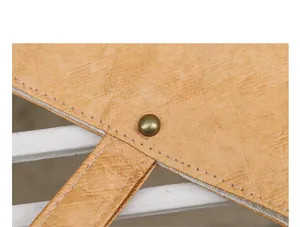 Close-up of wrinkled DuPont paper material with vintage rivet and stitching details