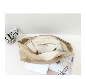 Detailed macro view showing the inner zipper pocket and lining of beige nylon shoulder bag