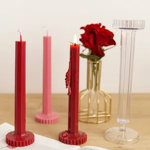 Detail view of octagonal ribbed acrylic candle mold with finished red pillar candles