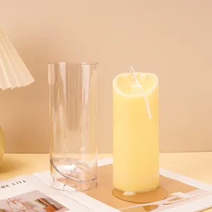 Detail of transparent acrylic cylinder candle mold and finished wavy top pillar candle