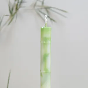 Macro detail of a green bamboo-shaped scented pillar candle featuring realistic texture